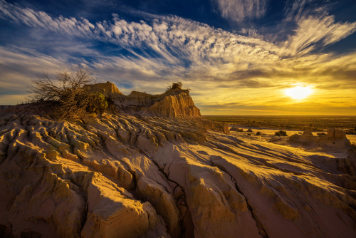 The dramatic, moon-like terrain of Mungo National Park, highlighting its ancient, eroded landscapes and the profound sense of history, a testament to its archaeological significance. 