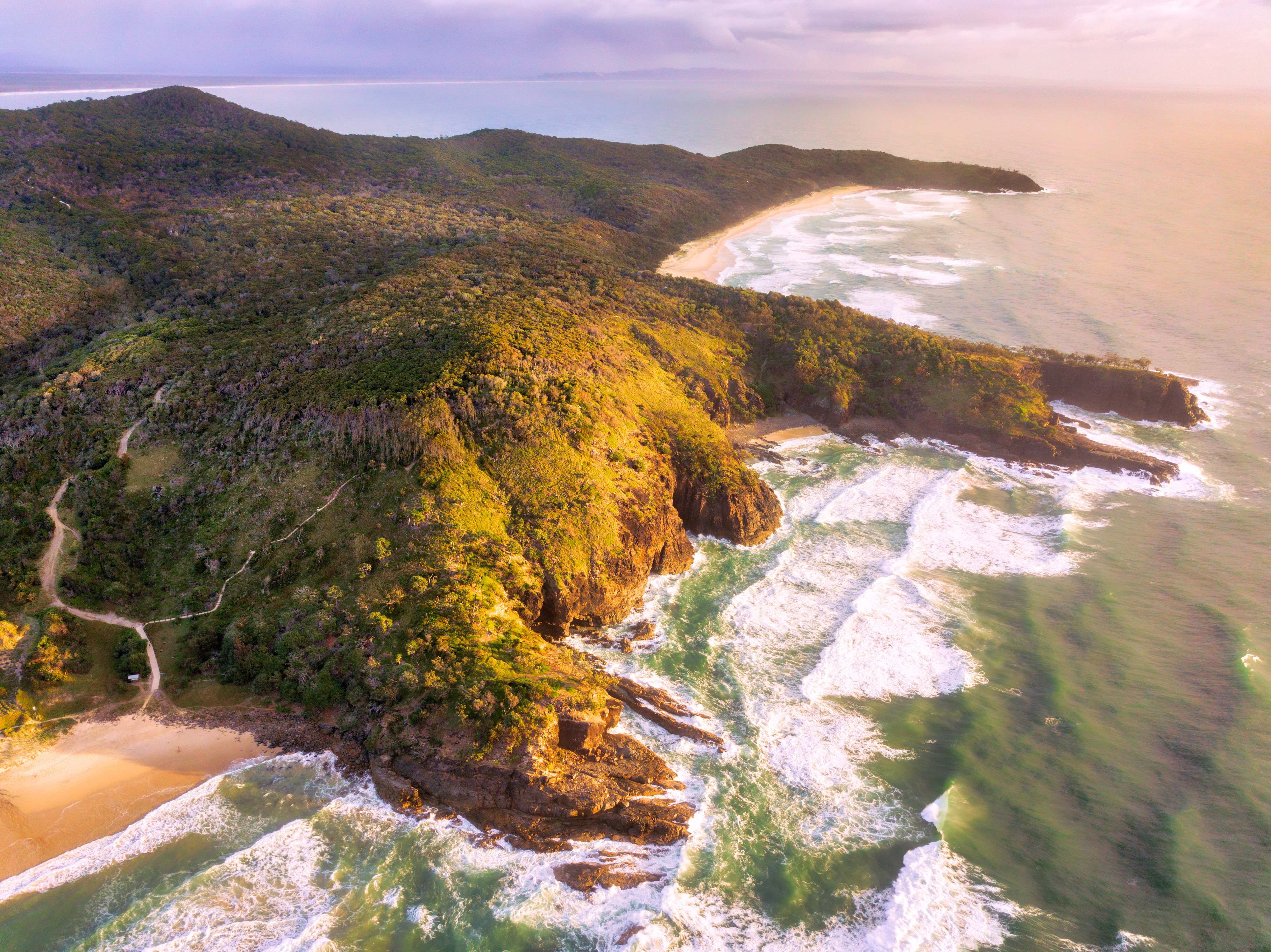 A scenic view from Noosa National Park, featuring coastal trails overlooking the turquoise waters of the Pacific Ocean. 