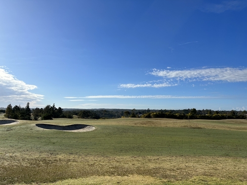 The lush fairways of North Turramurra Golf Course, with golfers enjoying a sunny day on the green. The course is perfectly integrated into the natural bushland setting, offering stunning views and a tranquil environment for golfing, reflecting the leisurely elegance and love for the outdoors that characterizes the Upper North Shore.