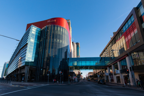 The bustling interior of Parramatta Westfield, captured during a busy shopping day. Shoppers navigate through the wide array of stores, the modern decor and lighting create a welcoming atmosphere for a diverse community of visitors, illustrating the shopping center's place as a key destination for retail and leisure in the heart of Parramatta. 