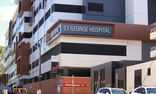 The modern facade of St George Hospital, a beacon of healthcare excellence in the community. The hospital stands proud, surrounded by well-maintained gardens, representing a place of healing, innovation, and care for the people of the St George area and beyond.