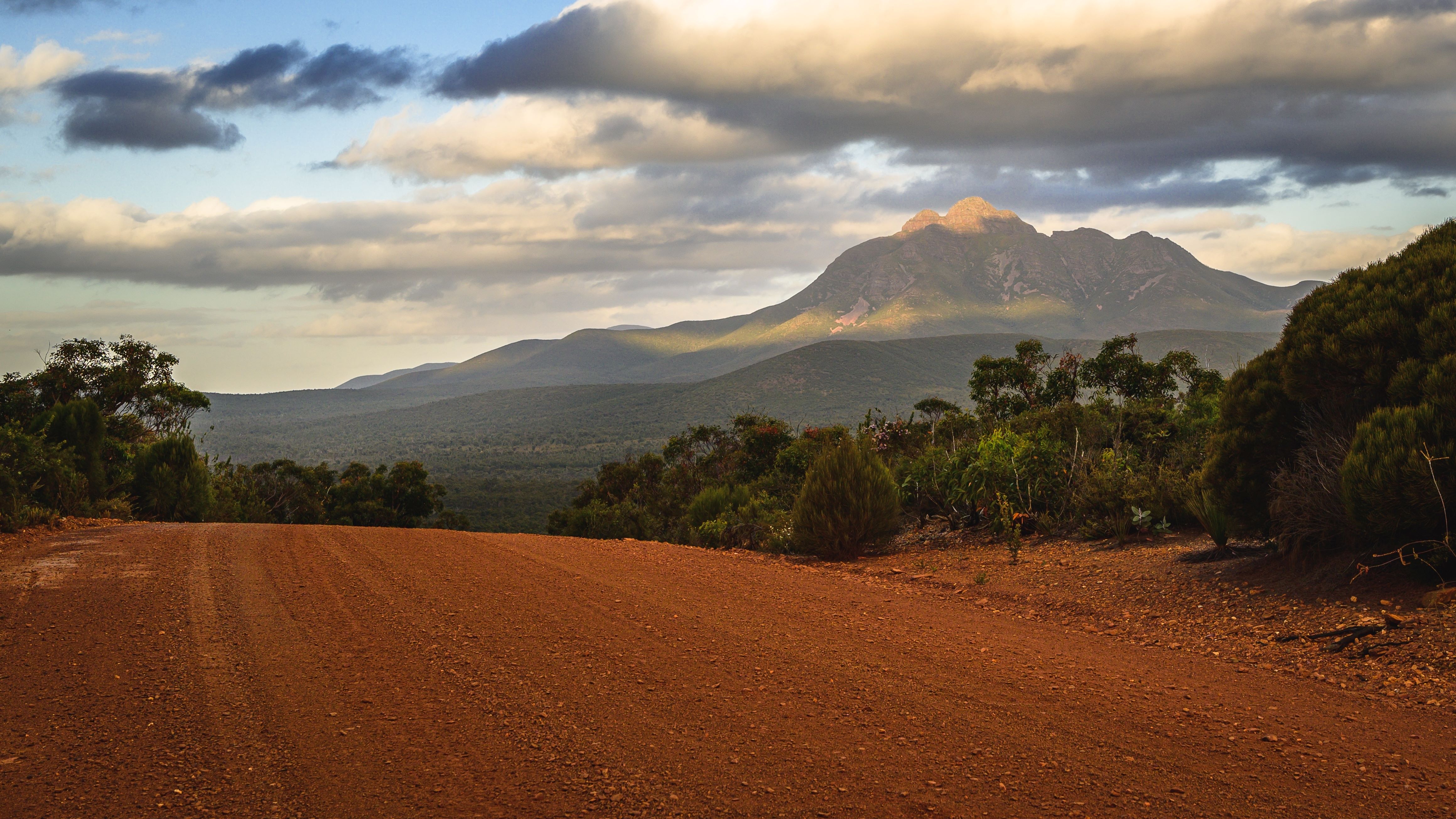 A stunning view from Stirling Range National Park, featuring rugged mountain peaks against a backdrop of blue skies. 