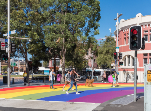 The lively ambiance of Taylor Square, where people gather amidst the bustling urban landscape, embodying the vibrant spirit and cosmopolitan character of the Inner East of Sydney.