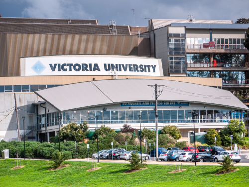 Aerial view of Victoria University's campus in Western Melbourne, highlighting its modern educational buildings surrounded by green spaces. The photo illustrates the university’s vibrant campus life with students actively engaged in their studies and social activities. This image emphasizes Victoria University's commitment to providing accessible education and its integral role in the intellectual and community development of Western Melbourne.