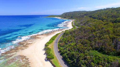 A breathtaking view along the Great Ocean Road, featuring the rugged coastline and the dramatic limestone stacks of the Twelve Apostles, epitomizing this iconic scenic drive.