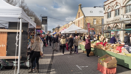 The bustling energy of Salamanca Market in Hobart, filled with colourful stalls offering local crafts, fresh produce, and a lively, welcoming atmosphere.
