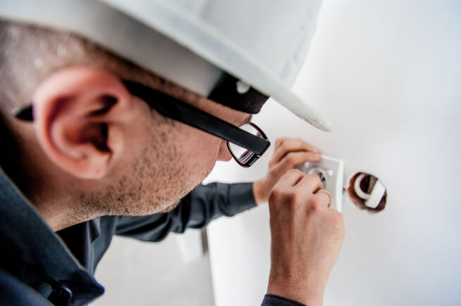 Electrician Fixing Wall Outlet