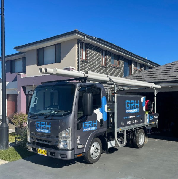 GRH Plumbing truck in front of house