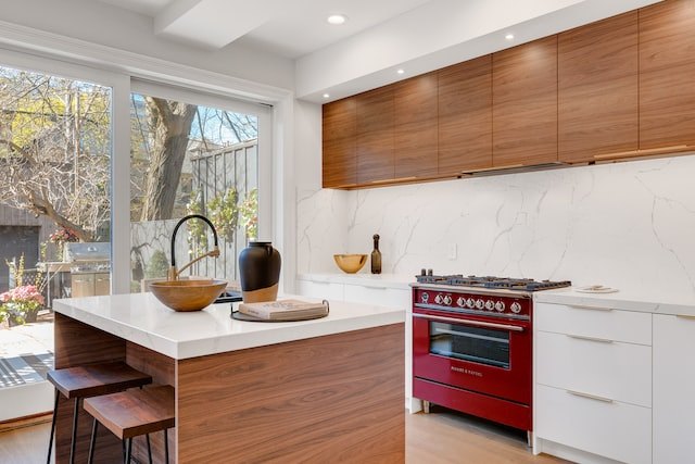 Modern kitchen with red gas stove