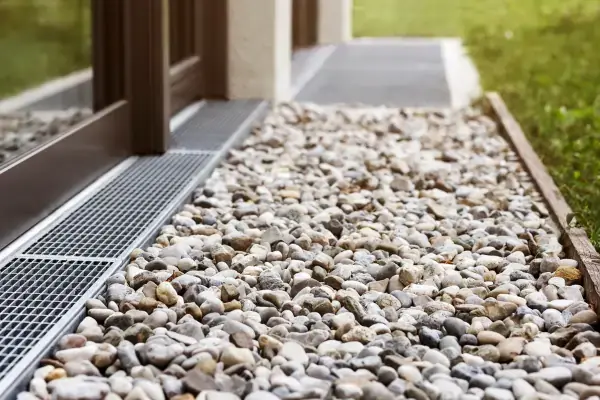 French drain with grate and rocks