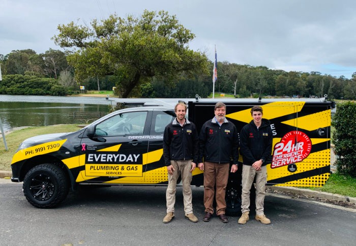 Three Everyday Plumbing & Gas team members stood with branded ute