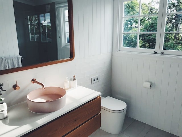 White bathroom with vanity and toilet
