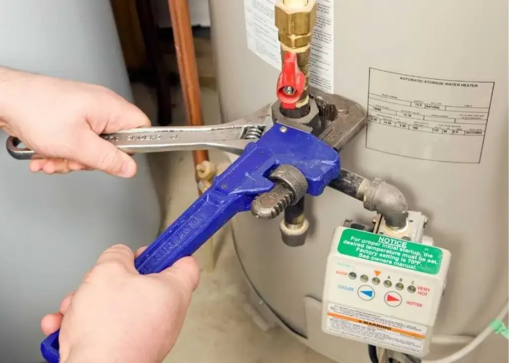 Gas Fitter tightening pipes with Wrench