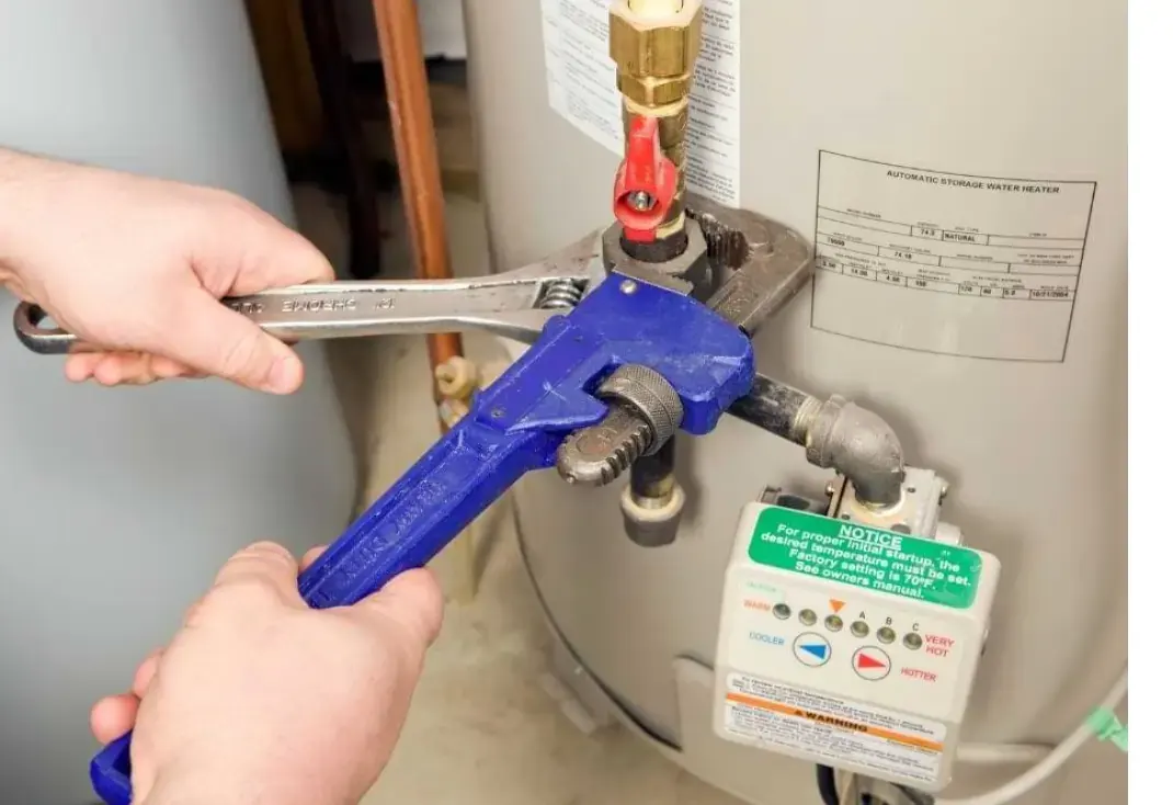 plumber installing a gas water heater