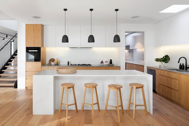 Island kitchen with timber and white cabinets