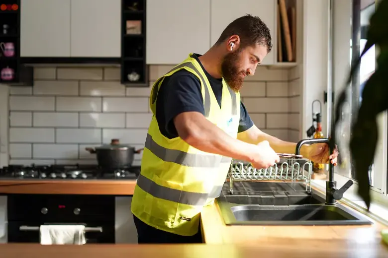 plumber fixing kitchen tap