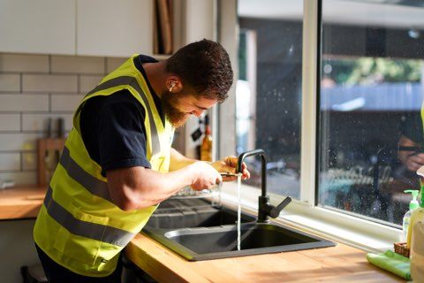 Kitchen Plumber fixing leaking tap