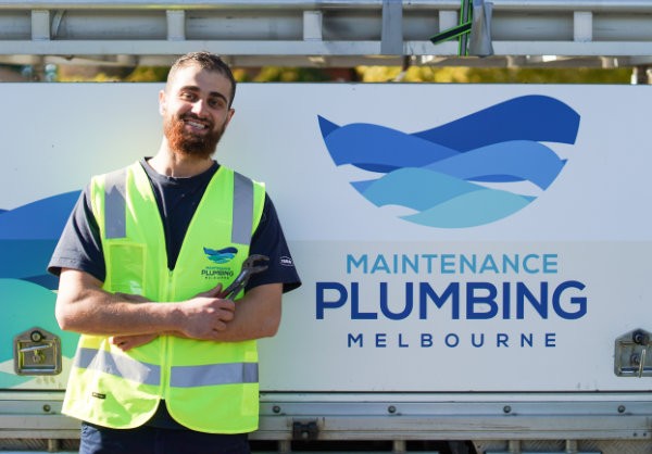Gas fitter standing with MPM Plumbing branded ute