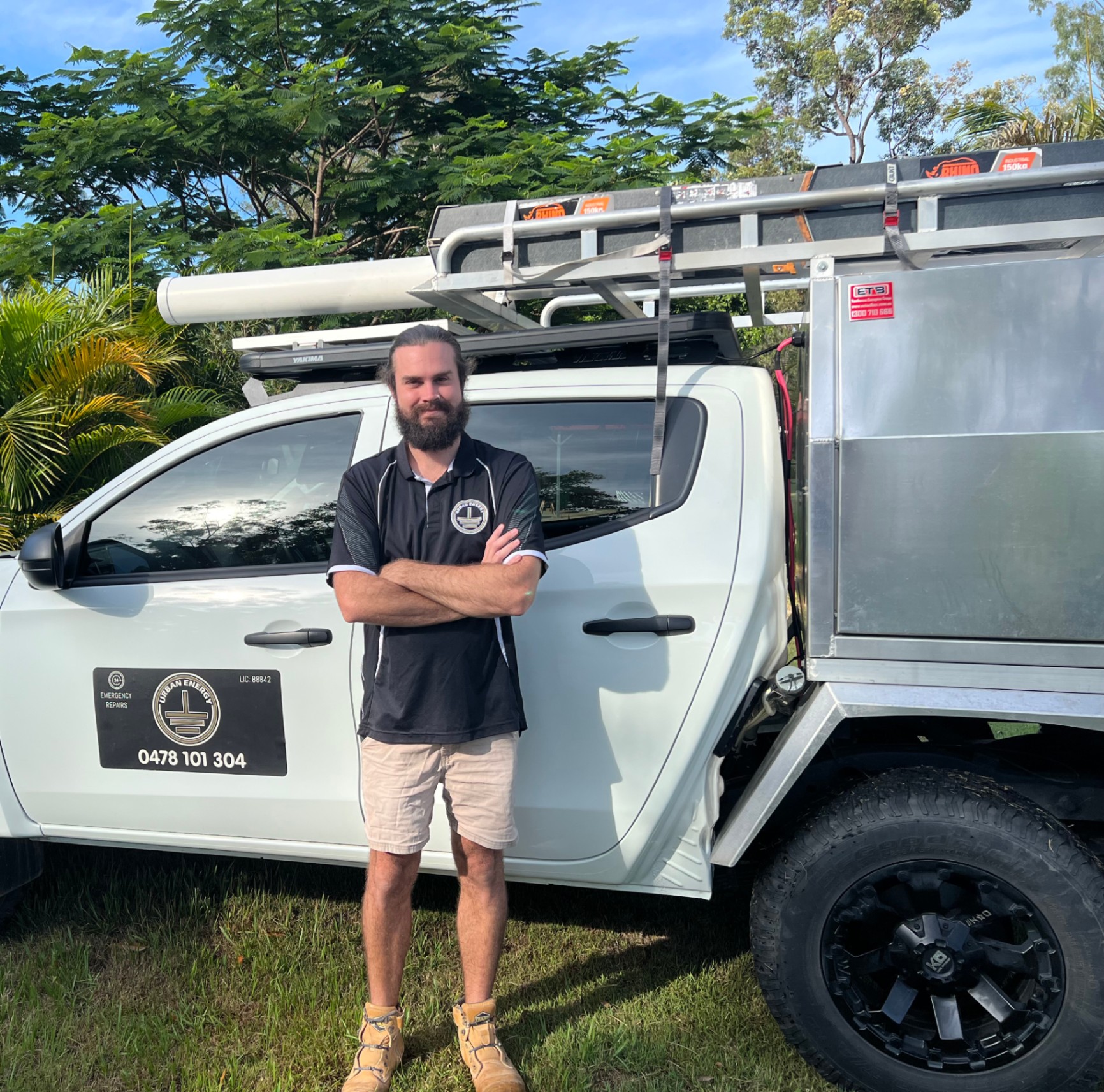 Urban Energy electrician stood with branded ute