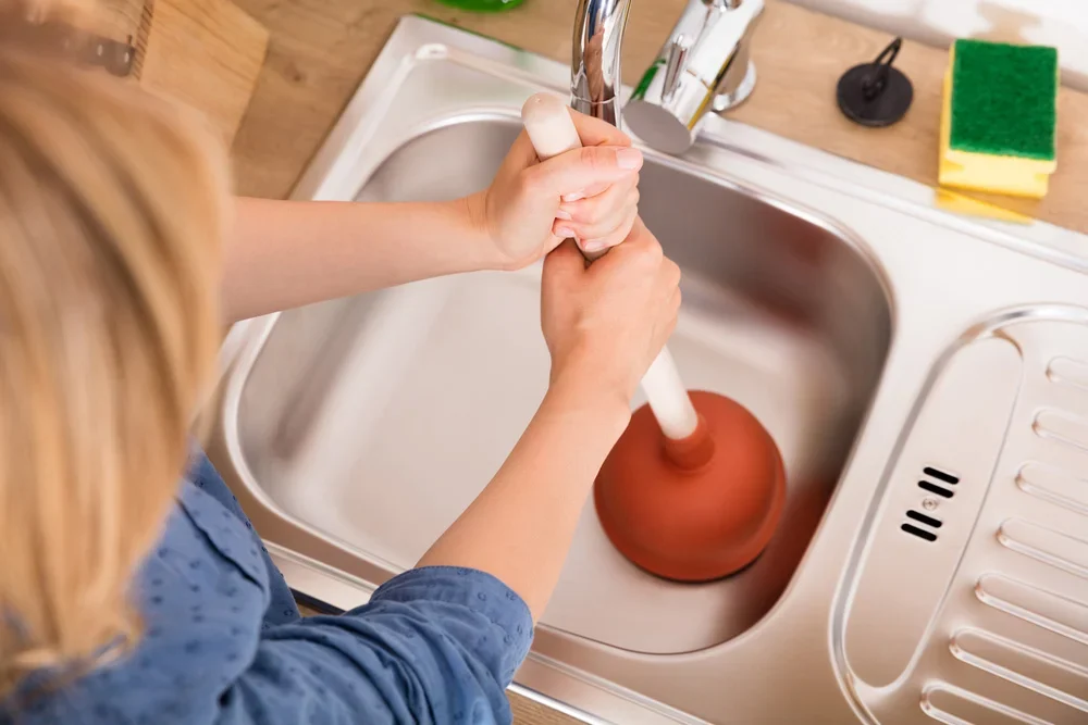 using a plunger in a kitchen sink