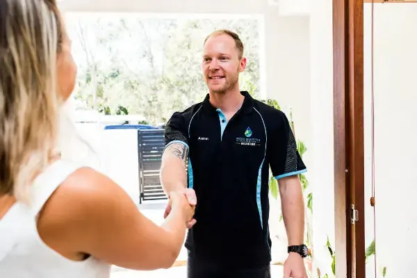 technicians shaking hands with a customer