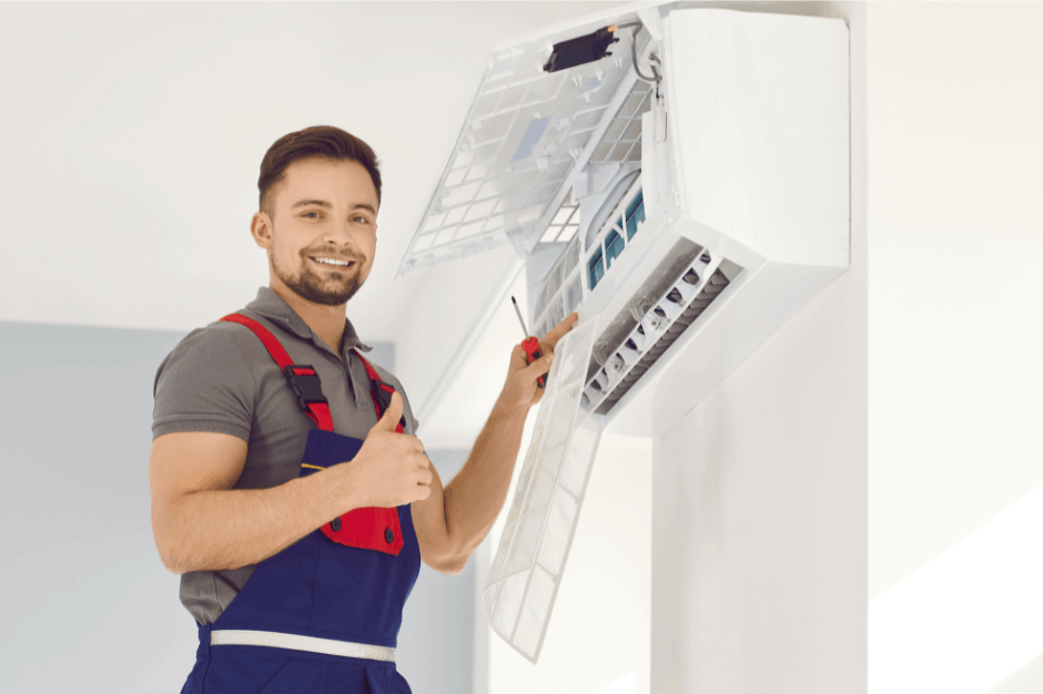Air conditioning technician servicing and cleaning a split system unit