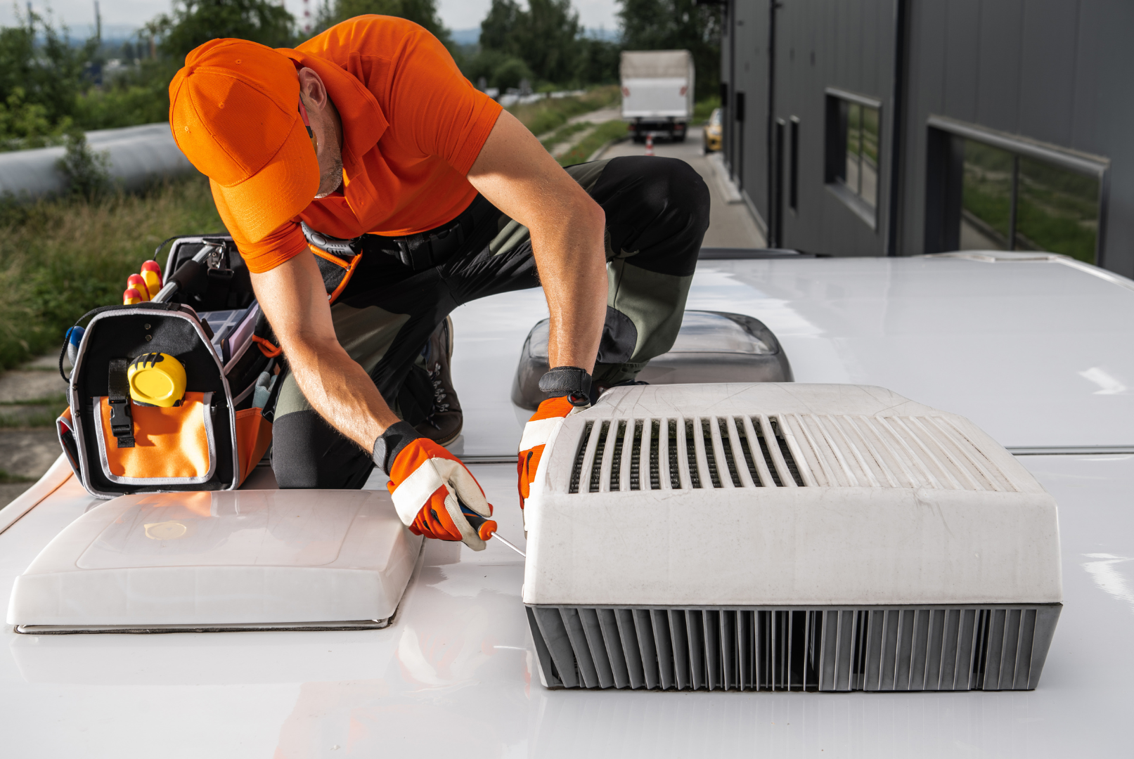 Specialist Caravan Air Conditioning Technician Servicing a Rooftop Air Conditioner Unit