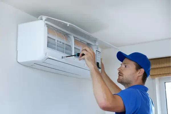 Technician installing a split system AC
