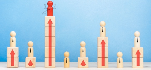 Business competition and Leadership concept with wooden figures of people symbol and arrow up on the table, blue background