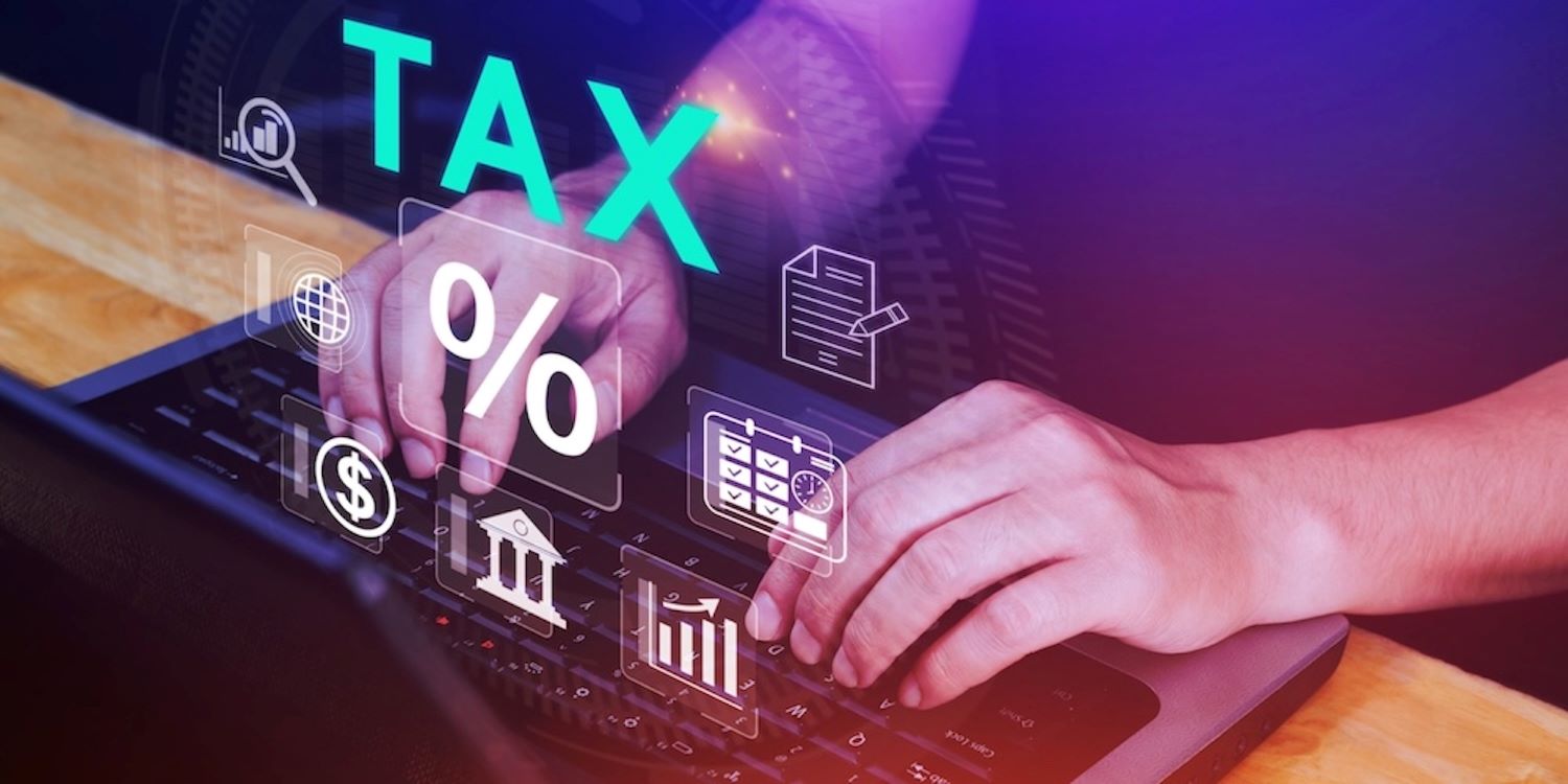 Accounting Advisory Insight Image. Man on keyboard & floating tax symbols