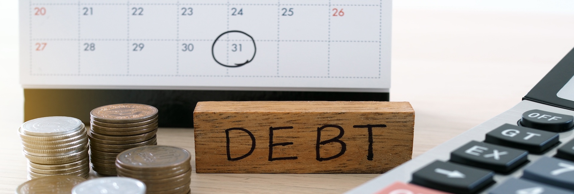 Debt concept with calendar and calculator and money - tax advisory accountancy audit