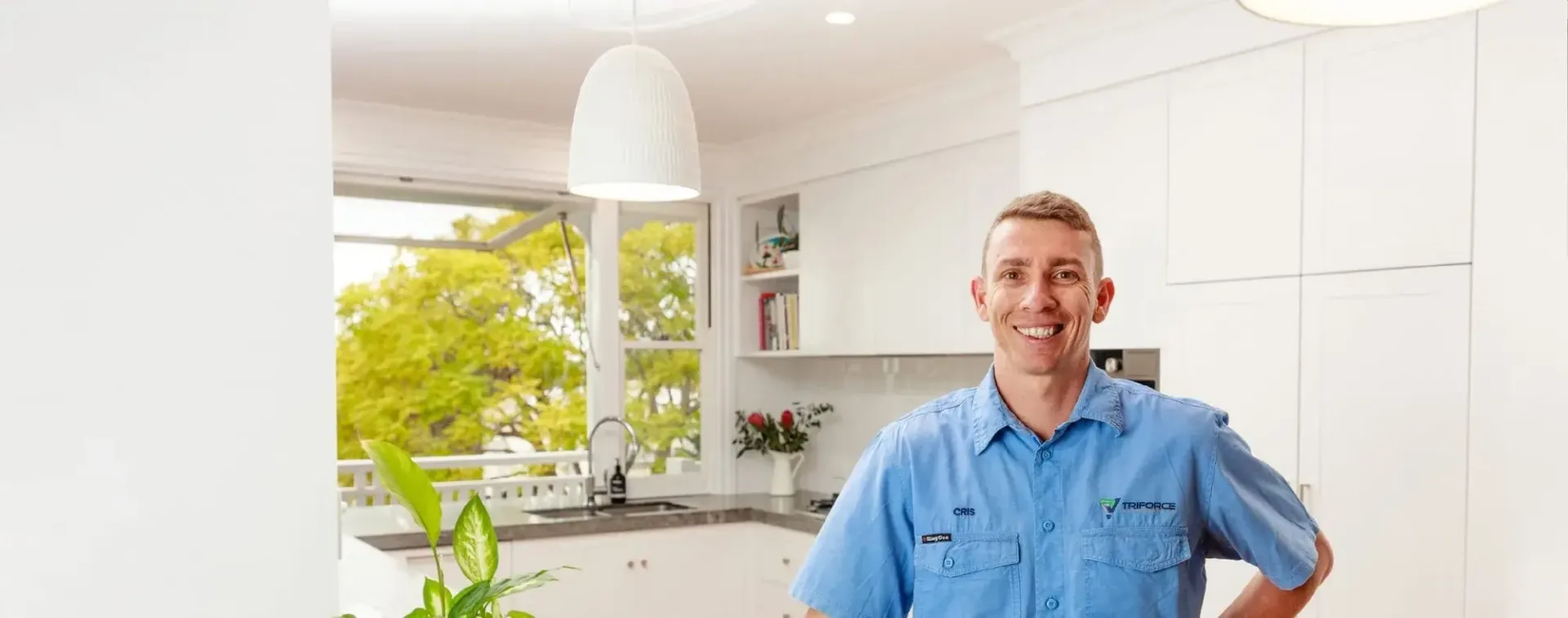 Licensed Triforce Master Electrician standing in kitchen with new electrical appliances that he has tested all smoke alarms throughout the property and provided a compliance certificate for the homeowner