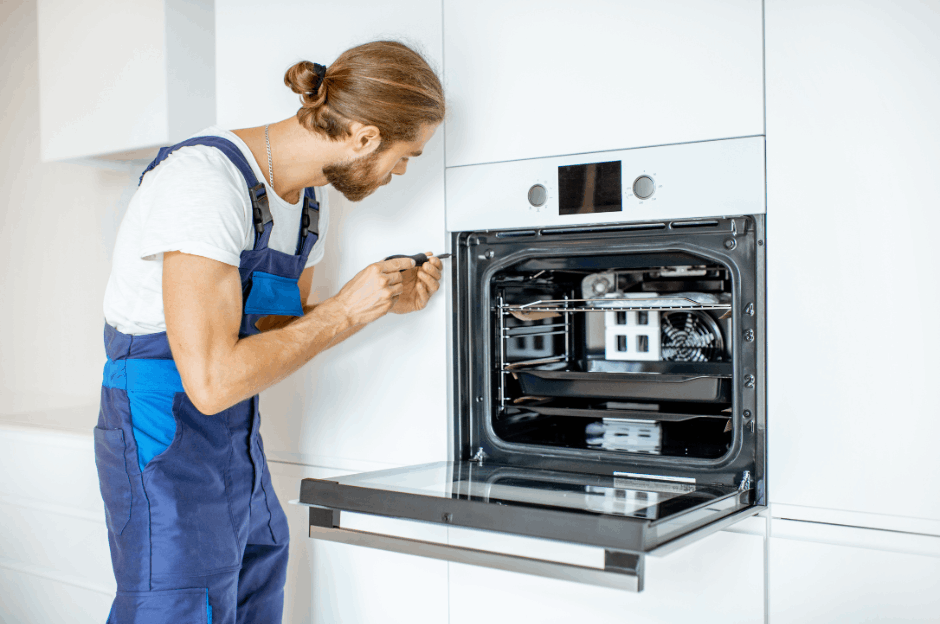 Electrician installing a new oven in kitchen