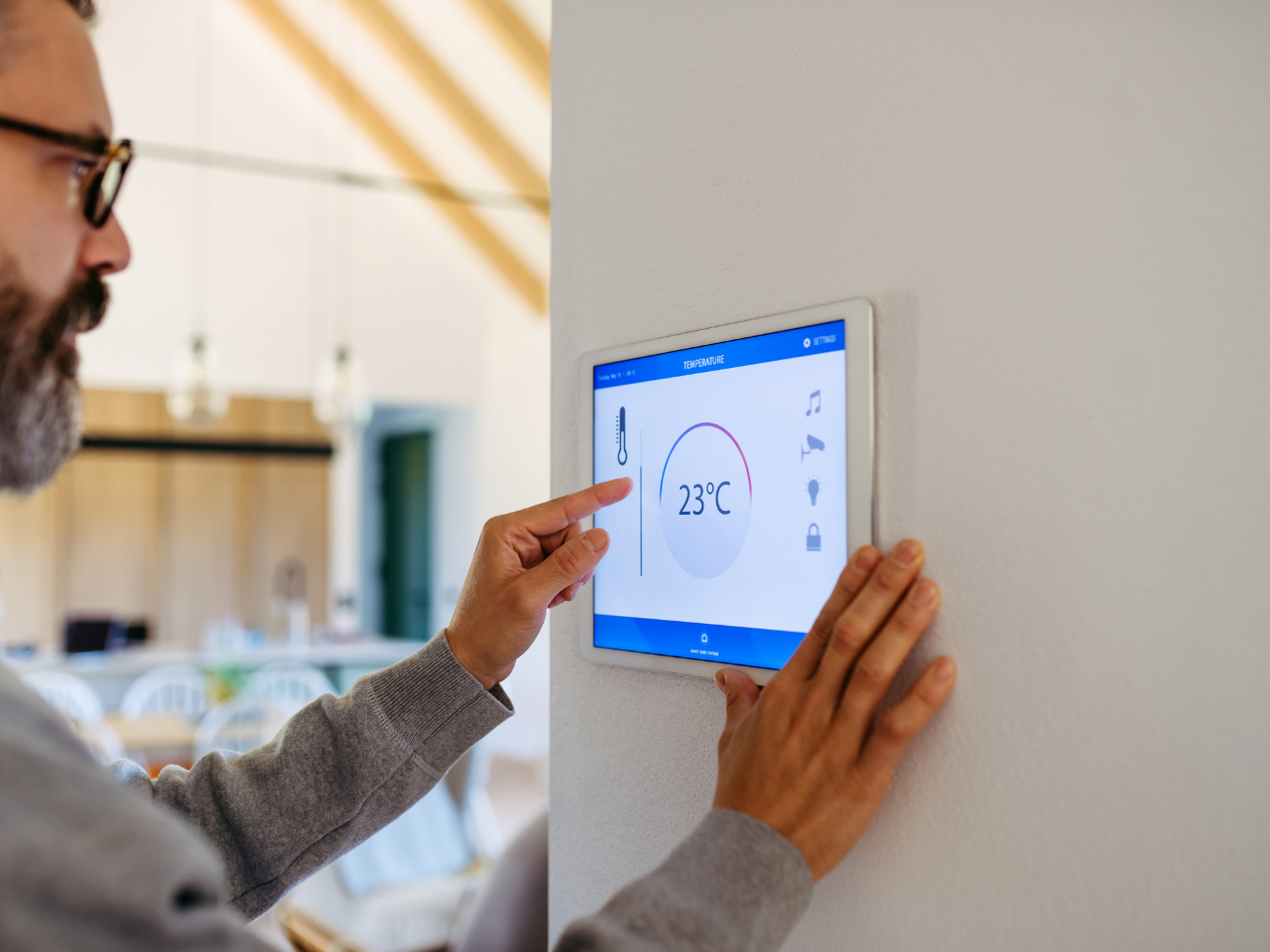 Man setting temperature of  ducted air conditioning