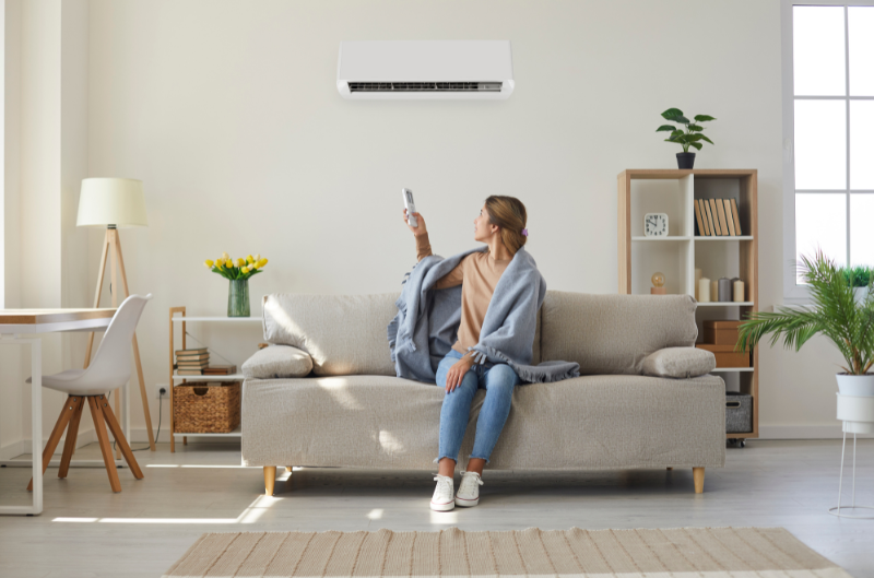 person utilising their air conditioner in winter for heating. keep warm whilst keeping your electricity bill down