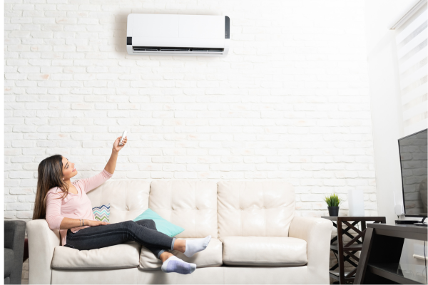 woman using remote control on AC
