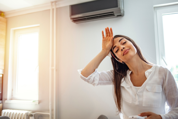 woman wiping brown in warm air conditioner room