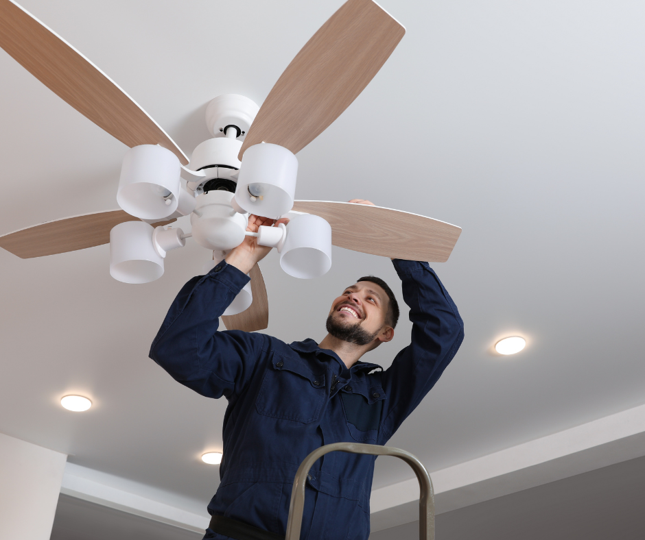 Electrician who is installing a ceiling fan in a home