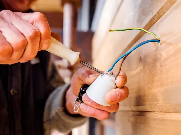 technician repairing electrical switch