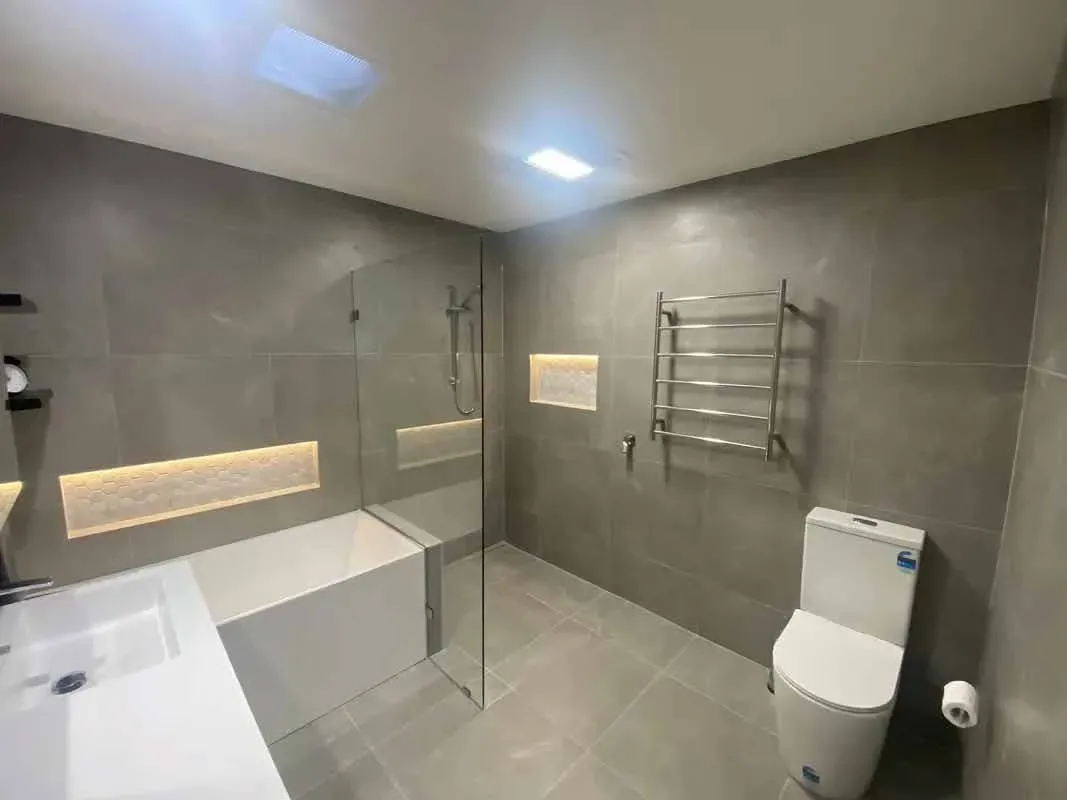 modern bathroom with white bath, toilet and sink