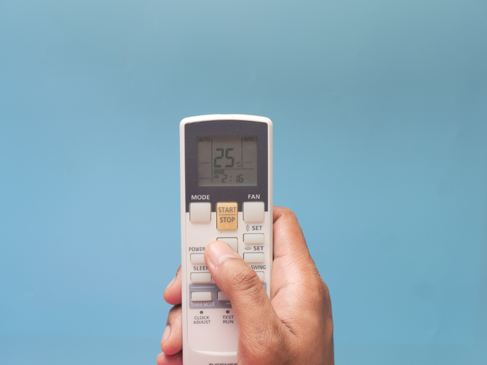 Air Conditioner Remote being adjusted