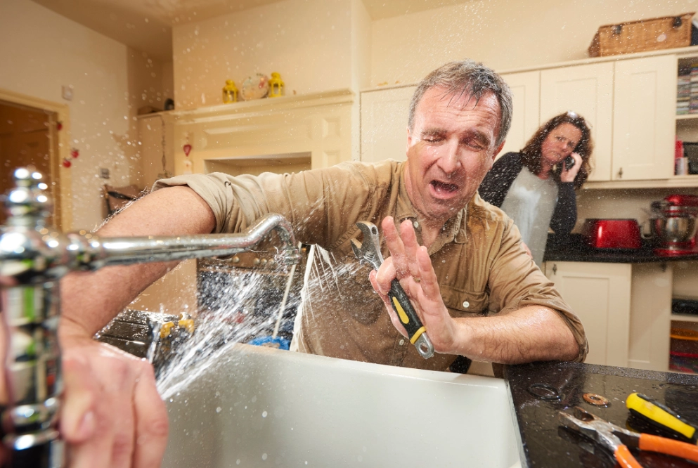 man getting wet for burst pipe
