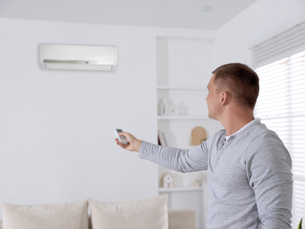 Man Adjusting Settings of Air conditioner