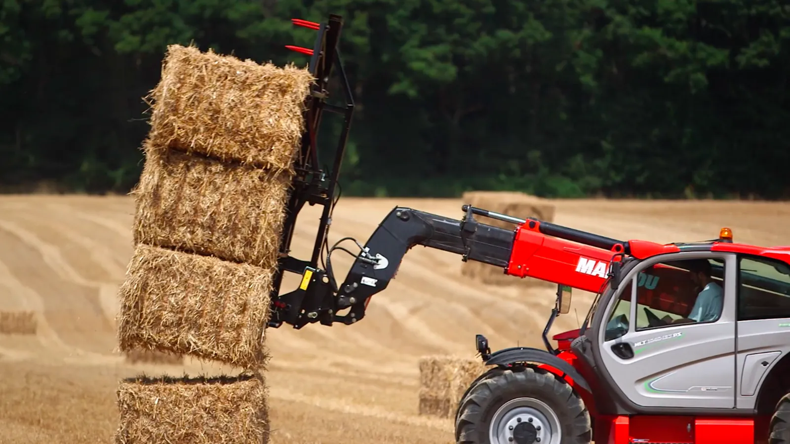 Telescopic Handlers on a farm moving haybales
