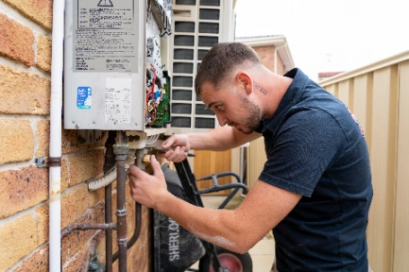 Licensed gas fitter from Steve's Plumbing testing gas hot water system for compliance to gain a gas compliance certificate