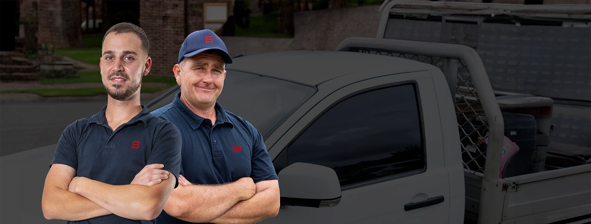 Steve's Plumbing plumbers stood in uniform smiling and ready to help with all your plumbing needs! stood with branded ute containing all universal plumbing parts to install, repair or service your plumbing system today!