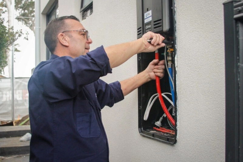 Our hot water plumber repairing a vulcan hot water system