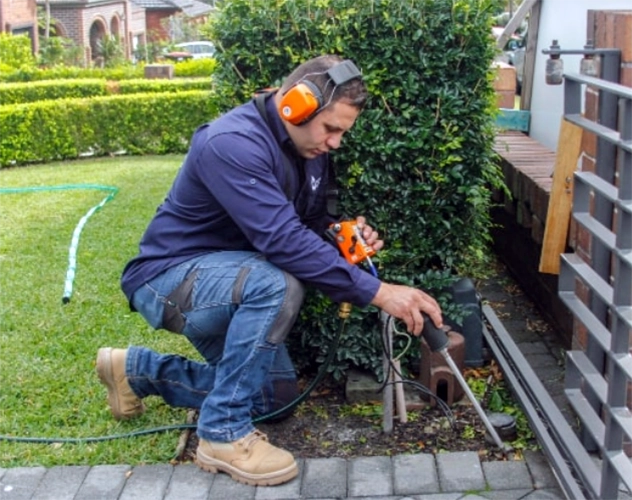 Plumber using technology to inspect a plumbing problem