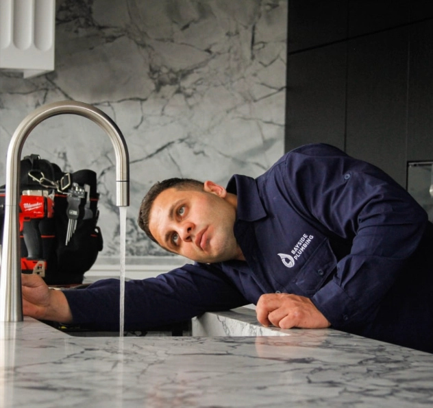Plumber testing a tap