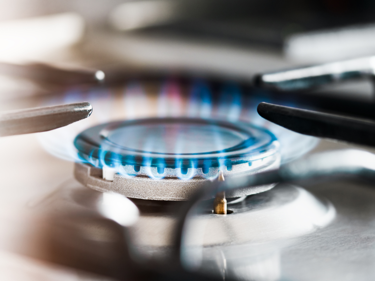 Bright blue flame on a gas stovetop